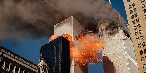 Smoke billows from one of the towers of the World Trade Center as flames and debris explode from the second tower, Tuesday, Sept. 11, 2001. (Photo | AP)