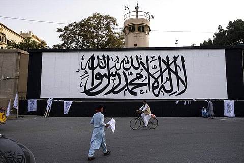 The Taliban flag is painted on a wall outside the American embassy compound in Kabul, Afghanistan, Saturday, Sept. 11, 2021. (Photo | AP)