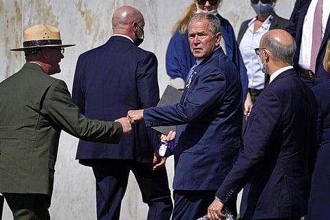 Former President George W. Bush, right center, bumps fists with Flight 93 National Memorial superintendent Stephen M. Clark. (Photo | AP)