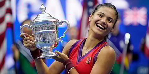 Emma Raducanu holds up the US Open trophy after defeating Leylah Fernandez during the women's singles final of the US Open tennis championships in New York. (Photo | AP)