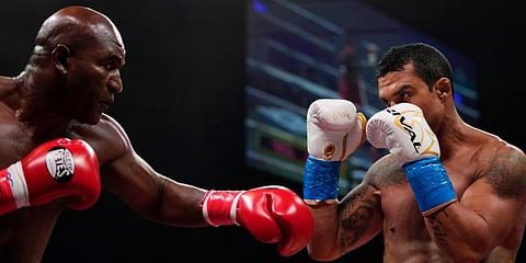 Former MMA star Vitor Belfort (R) defends against former heavyweight champ Evander Holyfield during a boxing bout in Hollywood, Fla. (Photo | AP)