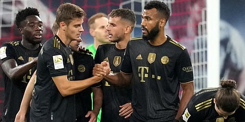Bayern Munich's Eric Maxim Choupo-Moting, second right, is congratulated after scoring his sides fourth goal during the German Bundesliga match against RB Leipzig in Leipzig. (Photo | AP)