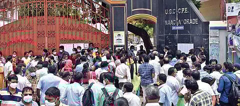NEET aspirants wait outside an exam centre set up at KBN college in Vijayawada on Sunday. (Photo | P Ravindra Babu)