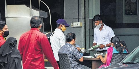 A restaurant at Palayam in Thiruvananthapuram serves customers through a temporary arrangement it made on its premises on Monday. | B P Deepu 