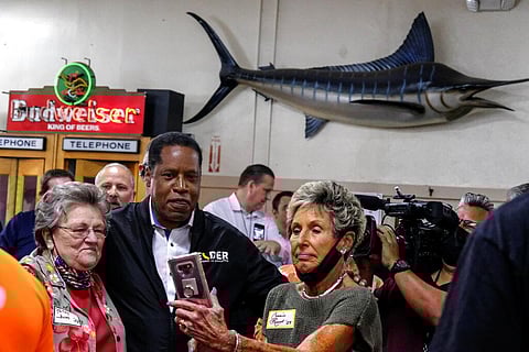 Republican conservative radio show host Larry Elder takes photos with patrons when he visiting Philippe The Original Deli. (Photo | AP)