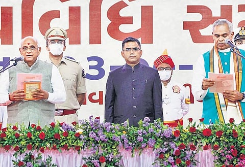 Bhupendra Patel (far left) being administered the oath of office by Governor Acharya Devvrat (far right) in Ahmedabad. (Photo | PTI)