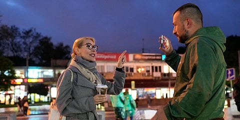 Alyona Popova, the democratic Yabloko party candidate for the State Duma, left speaks with a Communist party supporter during a meeting with voters in Moscow, Russia, Sept. 3, 2021. (Photo | AP)