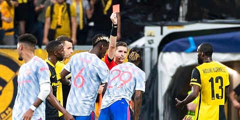 Referee Francois Letexier of France, center shows the red card to Manchester United's Aaron Wan-Bissaka (29). (Photo | AP)