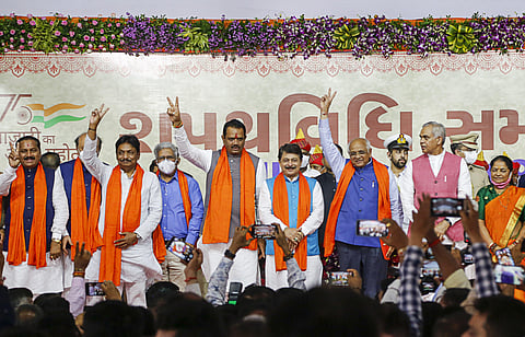 Newly appointed Gujarat Chief Minister Bhupendra Yadav with the State Cabinet Ministers during swearing-in ceremony, at Raj bhavan in Gandhinagar. (Photo | PTI)