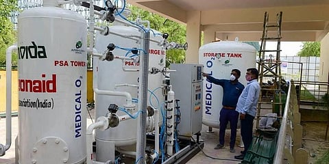 Engineers inspect an oxygen plant at a 50 bedded COVID-19 care centre, at a stadium in Noida. (Photo | PTI)