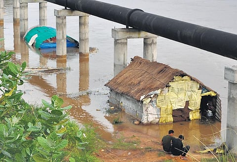 Huts submerged in flood water at Kathajodi slum in Cuttack. (Photo | Express)