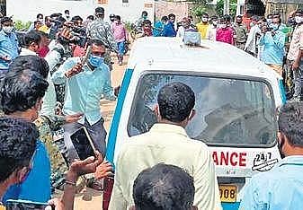 Enraged citizens hurl their footwear at the ambulance with Raju’s body in it