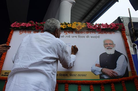 Bihar Chief Minister Nitish Kumar writes birthday wish for PM Modi on a whiteboard (Photo | Special Arrangement)