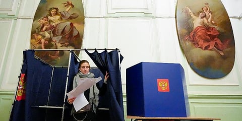 A woman prepares to cast her ballot during the State Duma, the Lower House of the Russian Parliament and local parliaments elections at a polling station in St. Petersburg, Sept 18, 2021. (Photo | AP)