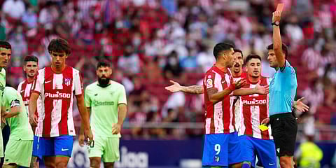Atletico Madrid's Joao Felix (walking off) is shown the red card. (Photo | AP)