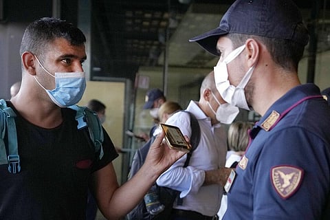 A police officer checks a passenger's phone at Porta Garibaldi train station, in Milan, Italy, Wednesday, Sept. 2, 2021.  (Photo | AP)