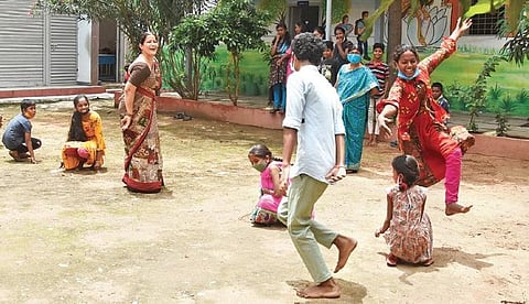 Students of Andhra Vidyalaya High School, Kattal Mandi play Kho kho along with their teacher during break on Wednesday. (Photo | R  V K Rao)