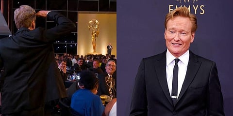 Conan O'Brien salutes Television Academy Chairman and CEO, Frank Scherma during the Primetime Emmy Awards.