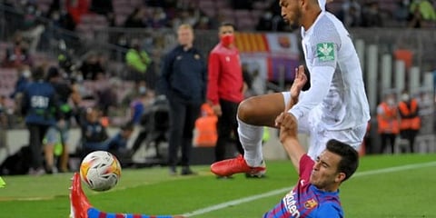 Granada forward Luis Suarez (R) vies Barcelona's Spanish defender Eric Garcia. (Photo | AFP)