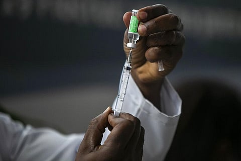 A healthcare worker prepares a dose of the AstraZeneca COVID-19 vaccine in Brazil. (Photo | AP)