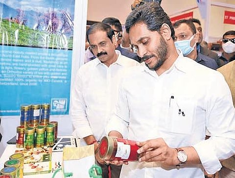Chief Minister YS Jagan Mohan Reddy examines a product at a stall at  Vanijya Utsavam 2021 in Vijayawada on Tuesday I Express