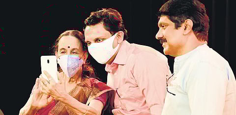 Singer and actress Subbalakshmi takes a selfie with Tourism Minister P A Mohamed Riyas as singer G Venugopal looks on