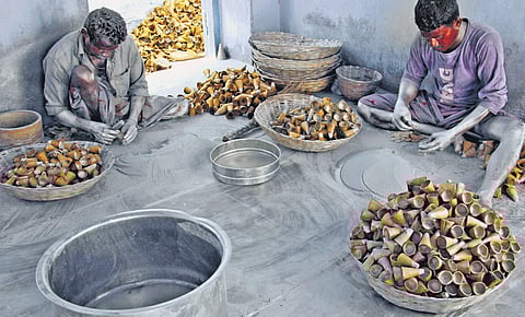 Two men are busy assembling shell for flower pots in Sivakasi | kk sundar