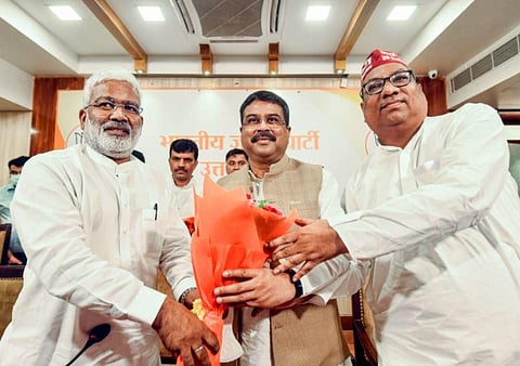 Union Minister and BJP's UP election incharge Dharmendra Pradhan being welcomed by chief of state unit of the party Swatantra Dev Singh (R) and Nishad Party president Sanjai Nishad (Photo | PTI)