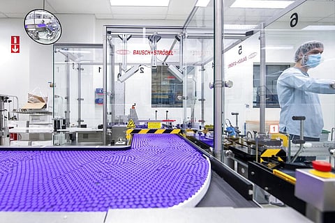 A technician works on a line for packaging preparation for the Pfizer-BioNTech COVID-19 vaccine (Photo | AP)