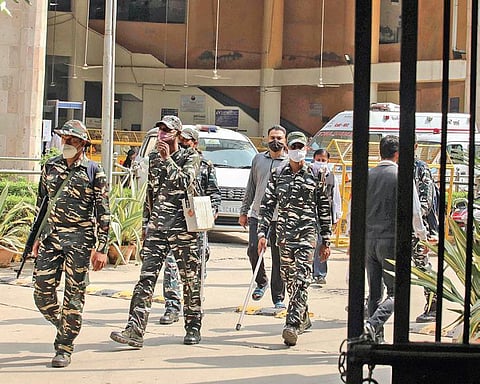 Police personnel at the Rohini court complex after the shootout; (R) people gather outside the court complex after Friday’s incident. (Photo | PTI)