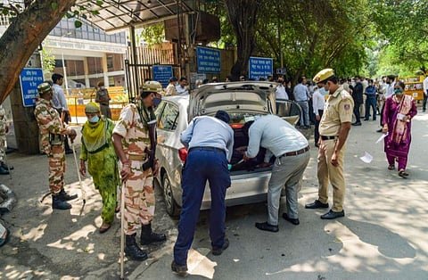 Delhi Police personnel check a vehicle at the Rohini Court, a day after the shooting incident, in New Delhi. (Photo | PTI)