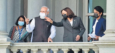 PM Narendra Modi talks with Kamala Harris on the balcony of the Eisenhower Executive Office Building in Washington. (Photo | PTI)
