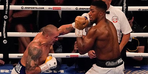 Oleksandr Usyk of Ukraine (L) throws a punch at Anthony Joshua of Britain during their WBA (Super) boxing title bout at the Tottenham Hotspur Stadium in London. (Photo| AP)