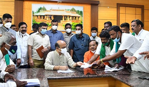 Chief minister Basavaraj Bommai receiving a memorandum from farmers. (Photo | Express)