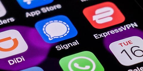 This photo illustration shows the encrypted messaging app Signal (C) pictured on a smartphone home screen in Beijing. (Photo| AFP)