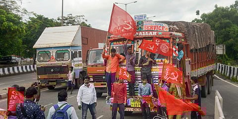 Members of Sanjukta Krushak Morcha block the NH 16 in Bhubaneswar during Bharat Bandh against central government's three farm reform laws. (Photo | PTI)