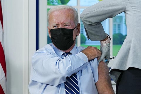 President Joe Biden receives a COVID-19 booster shot during an event in the South Court Auditorium on the White House campus. (Photo | AP)