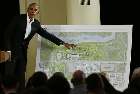 Barack Obama points to a rendering for the former president's lakefront presidential center at a community event at the South Shore Cultural Center in Chicago. (Photo | AP)