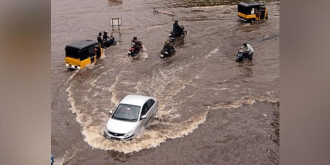 Vehicles move through a flooded Vizag road on Monday. (Photo | G Satyanarayana, EPS)
