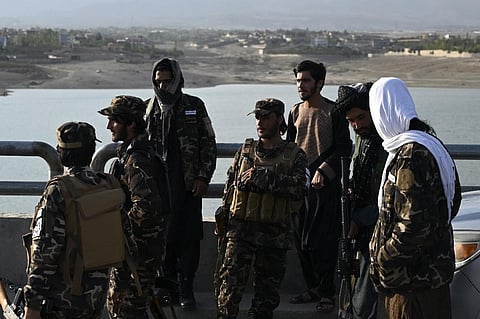 In this photograph taken on September 28, 2021 Taliban fighter patrol along a road at Qargha Lake on the outskirts of Kabul. (Photo | AFP)