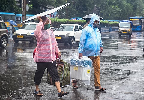 Polling officials carrying voting materials leave for poll duty amid rains, on the eve of Bhowanipur constituency by-poll, in Kolkata. (Photo | PTI)