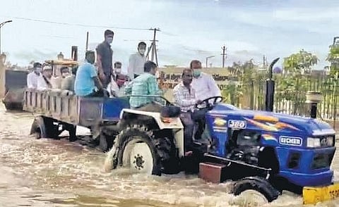 Rajanna-Sircilla Collector Anurag Jayanti, who was stranded in his camp office at the newly constructed Collectorate complex, being evacuated in a tractor.