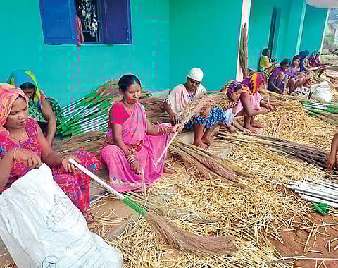 Tribal women making brooms from hill grass in Kotia. (Photo | Express)