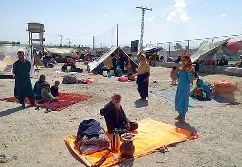 Afghan families sit outside their tents in an open area on the outskirts of Chaman, a border town in the Pakistan's southwestern Baluchistan province, Wednesday, Sept.1, 2021. (Photo | AP)