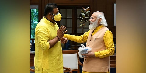 Prime Minister Narendra Modi chats with Suresh Gopi after receiving the guava sapling