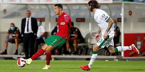 Portugal's Cristiano Ronaldo (L) passes the ball during the World Cup Qualifier against Ireland. (Photo | AP)