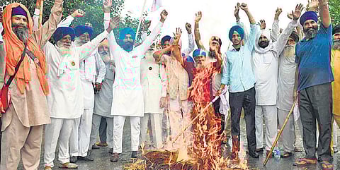 Farmers protest against the Centre’s agricultural reforms in Amritsar on Friday | AFP