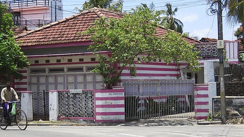 A man on a bicycle pedals past the family home of Ahamed Aathil Mohamed Samsudeen, an Islamic State-inspired extremist, in the eastern Sri Lanka town of Kattankudy. (Photo | AP)