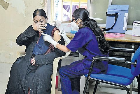 A health worker administers Covid-19 vaccine to a beneficiary at a  health centre in Bengaluru. (Photo | Shriram BN, EPS)