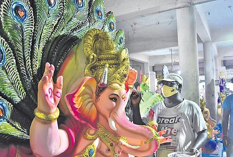 An artist giving final touches to Lord Ganesh idols ahead of Ganesh Chaturthi at Nunna in Vijayawada on Sunday | P  Ravindra Babu